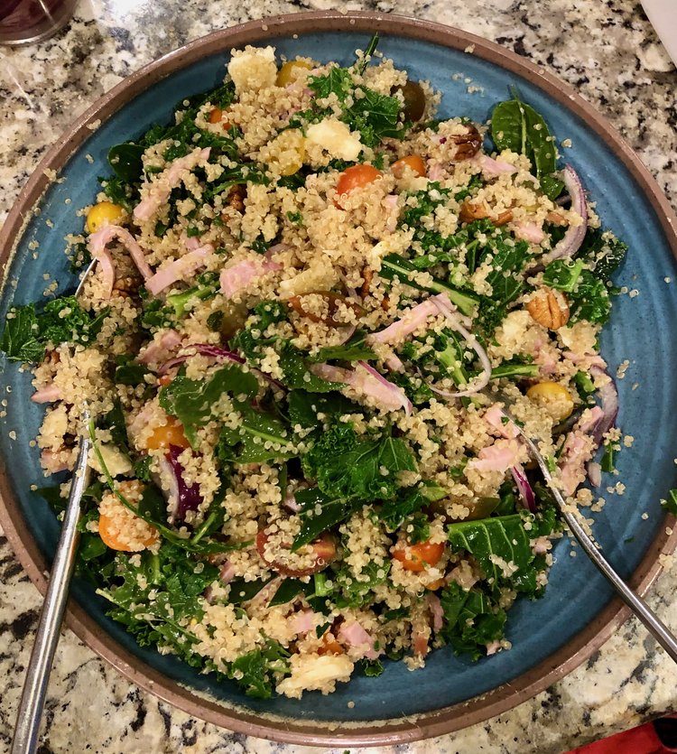 on a grey counter, blue serving bowl with salad inside